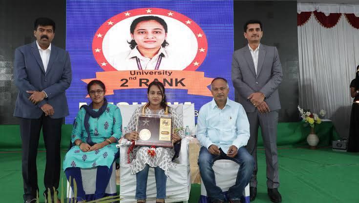 An award recipient at a felicitation gathering with the management, principal and accompanying guests